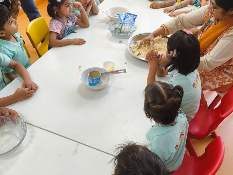 Children working together at a low table in an open classroom learning centre