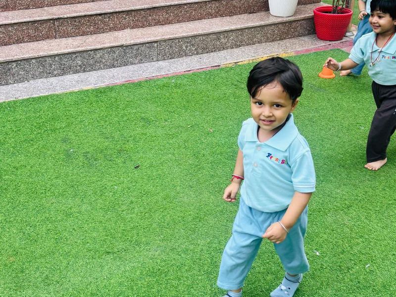 Children running and playing on the outdoor turf