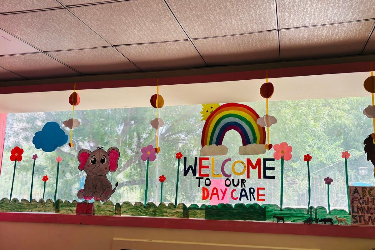 The painted Welcome to our Day Care mural on the wall of the DLF Phase 3 day care room