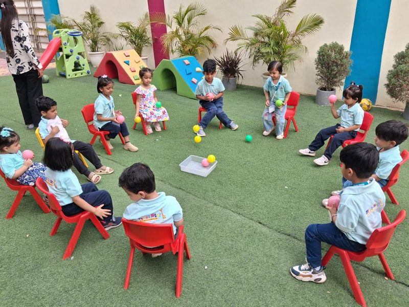 Children playing in the outdoor play area with slides and climbing frames