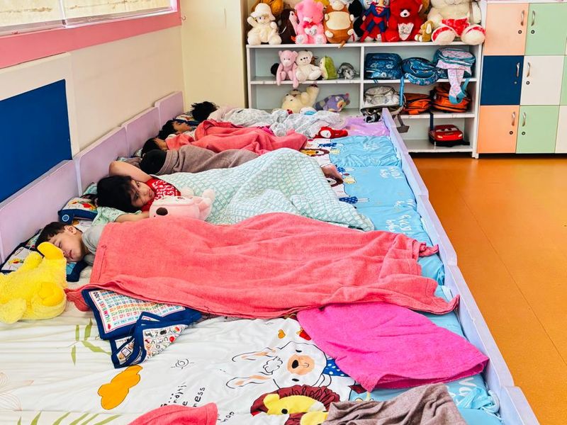 Low beds made up with blankets and pillows in the day care sleeping area