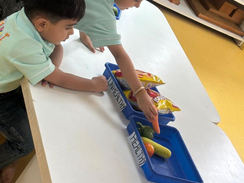 A child matching coloured pegs on a sorting board
